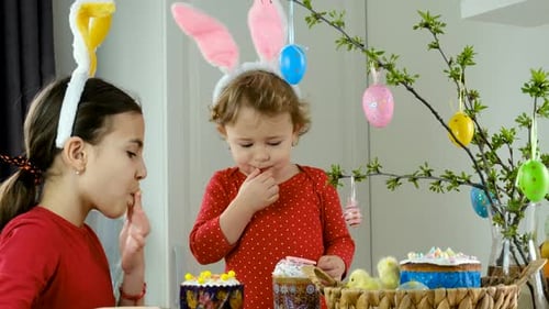 Girls Wearing Bunny Ears Decorating Easter Table