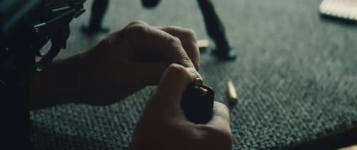 Hand Loading Bullets into Gun Magazine Close Up