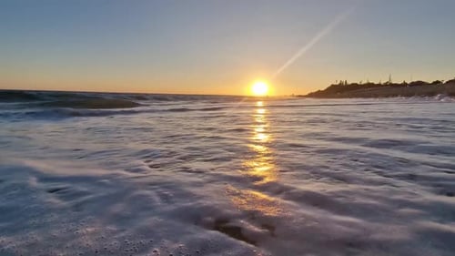 Golden Sunset on Beach Frothy Waves Roll on Sand of Beach Under Low Sunlight Slow Motion Nobody
