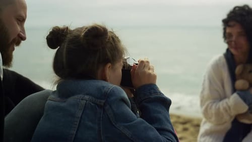 Happy family enjoying spring holiday photoshoot on ocean coast beach