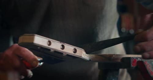 Craftsman Filing Guitar Neck in Workshop