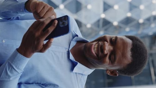 Vertical Video Smiling African American Business Man Standing Outside and Using Smartphone Positive