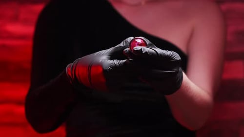 Woman Holding Red Gemstone in Black Glove Woman Holding Red Gemstone in Black Glove