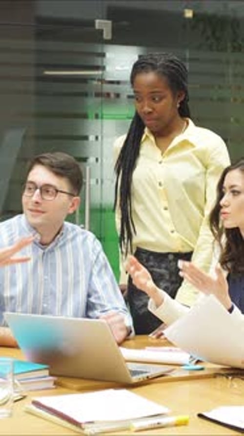 A Group of People Discusses a Startup with Colleagues in a Stylish Office