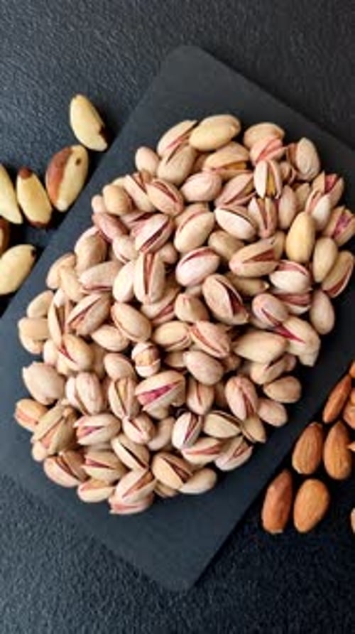 Salted pistachio nuts in shells as a healthy, high calorie food ingredient. Pistachio nuts