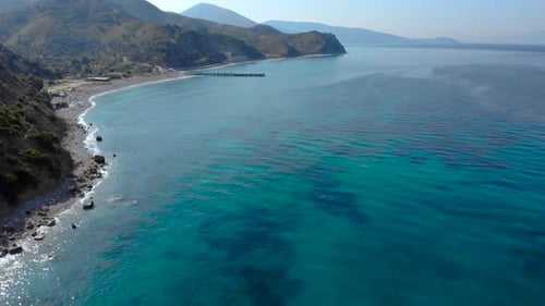 Colorful seascape with azure sea water on remote beach surrounded by green hills in Mediterranean