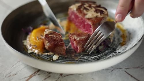 delicious meat in medallions on a plate in a restaurant. cuts a steak