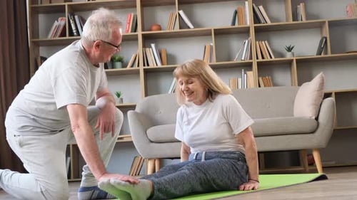 Mature Couple Doing Leg Stretching Exercise at Home