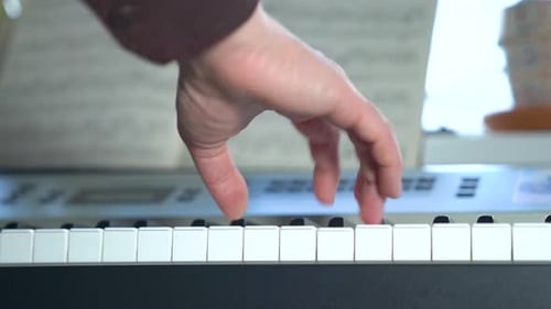 Close up of Hand Playing Piano Keys