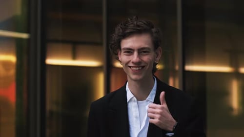 Portrait of a Professional Businessman Smiling and Giving Thumbs Up Outdoor Near Modern Office A