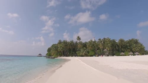 Paradise white sand beach, palm trees and azure ocean in luxury Maldives resort