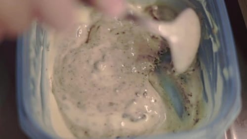 Chocolate filling is chopped up with a silver spoon to make pancakes, close up