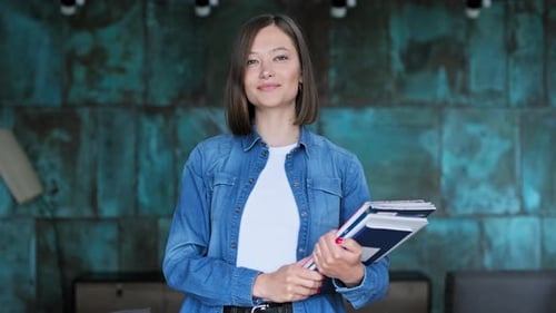 Portrait of Young Female University Student with Textbooks in Home Interior