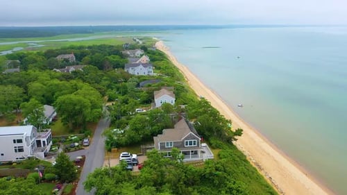 Cape Cod Coastline with Beach Houses and Cloudy Skies from Above