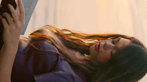 Beautiful Woman Reading a Book at Sunrise