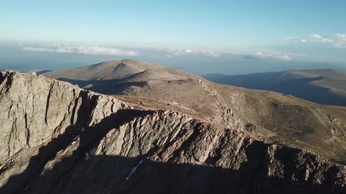 Mount Evans Peaks, Colorado. Aerial View on Rugged Mountain Under Beautiful Sky and Golden Hour Sunl