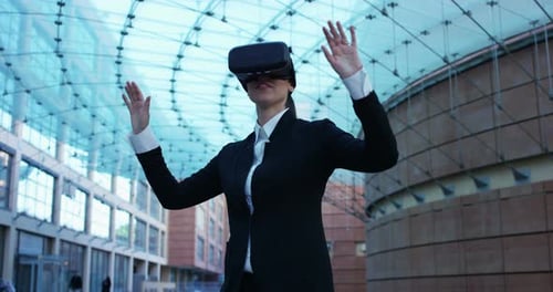 Businesswoman Experiencing VR in Modern Urban Setting