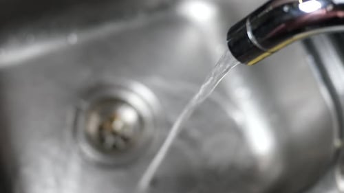 Water Running From Faucet into Kitchen Sink