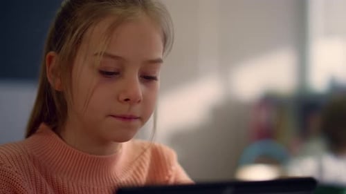 Portrait of Diligent Student Reading Book on Digital Tablet at Lesson In