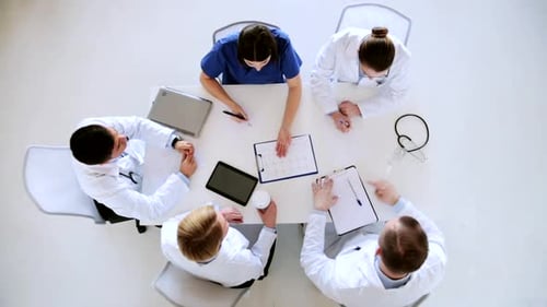 Healthcare team doctors reviewing cardiogram results at hospital meeting