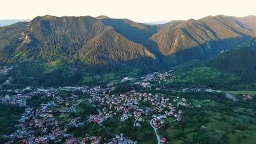 View From Rock to Town of Smolyan with Meadows for Cattle Walking and Houses Between Mountain Range