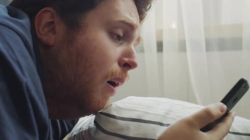 Man Wakes Up and Checks His Cell Phone