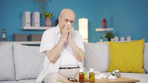 Senior Man with a Cold Blowing Nose