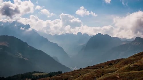 Discover a stunning view of mountain peaks emerging from a sea of clouds 4K