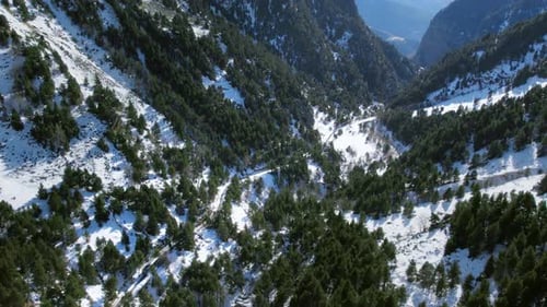 Cinematic Aerial Drone Shot Following Train in Snow Mountain Landscape