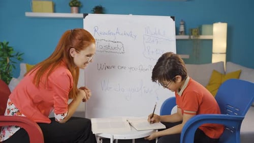 Girl Helping Boy with Homework at Home
