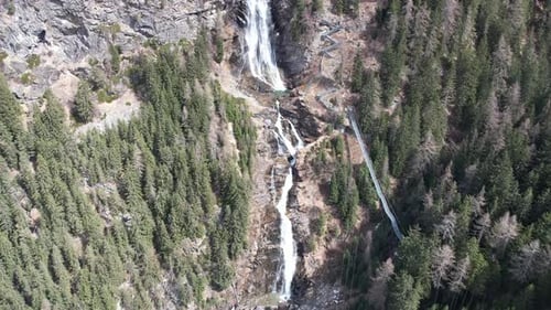 Aerial drone view of a cliff waterfall in the Tyrol