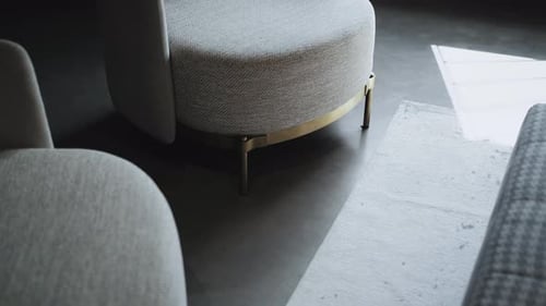Gray Fabric Minimalist Chair in Loft Stile Office Closeup Part of Chair with Metal Legs Handheld