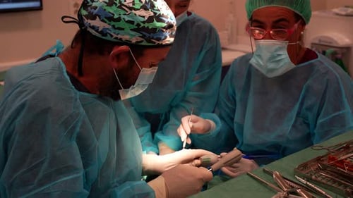 Dental procedure with dentists performing tooth extraction surgery and blood aspiration