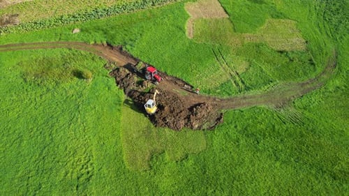 View from Above Of Backhoe Scooping Soil On The Field. Zas, A Coruna, Spain. aerial shot