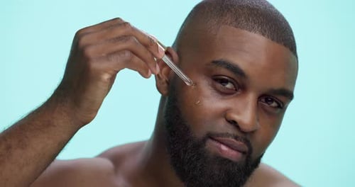 Serum, skincare and face with black man in studio for beauty cosmetics, dermatology and self care