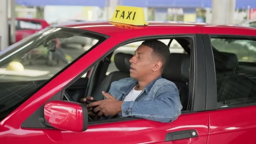 Taxi Driver Counting Money in a Red Car