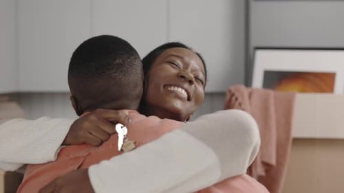 Close View of the African American Woman Hugs Her Husband Because He Buy a New Home for Them