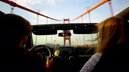 Couple drives jeep across Golden Gate Bridge in San Francisco California