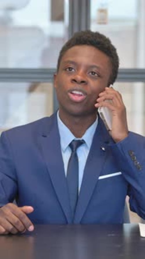 vertical video of African Businessman Talking on phone in Office