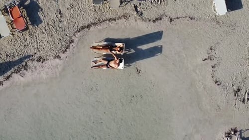 Aerial View of People Sunbathing on Beach