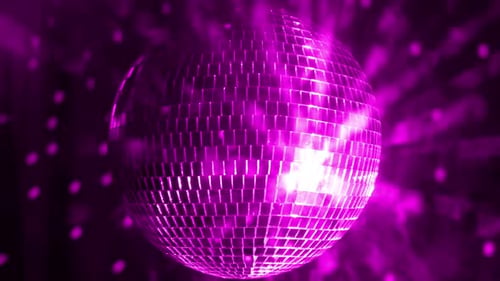 Disco ball reflects vibrant colors at an evening dance party