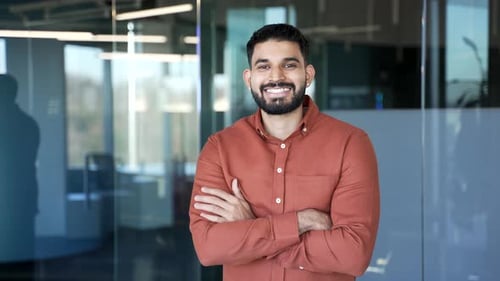 Confident Young Man Poses in Modern Office