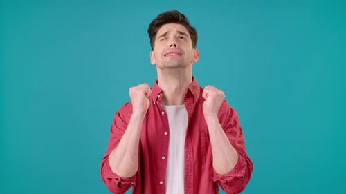 Young Man Hoping and Wishing with Crossed Fingers