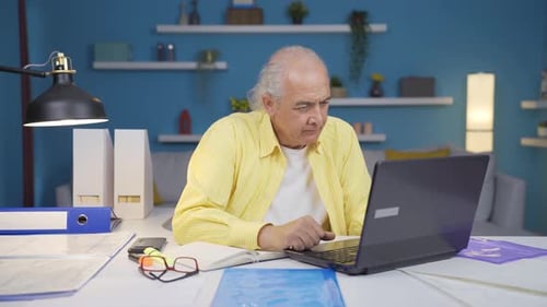 Ambitious and determined portrait of home office worker old man.