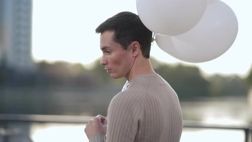 Young Man With Balloons Outdoors
