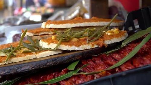 Tapas selling on the market. Traditional Spanish dish or fingerfood on the marketplace next to dried
