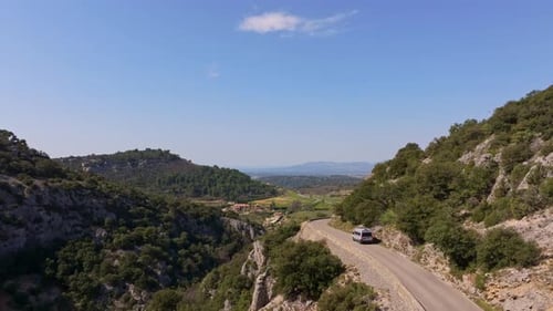 Aerial view of motorhome driving scenic cliffside route D177 in Provence