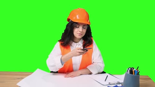 Female Architect Making Photo of Blueprint By Smartphone on the Chroma Key