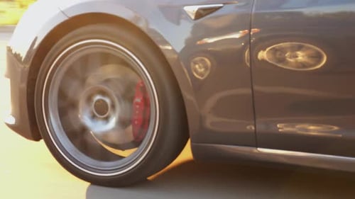 Wheel of Modern Electrical Automobile Driving at Urban Road on Sunny Day Ecology Friendly Car Riding