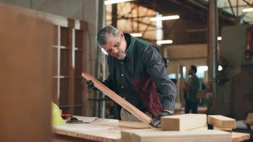 Carpentry, woodwork and man in workshop for sanding wood for furniture, manufacturing